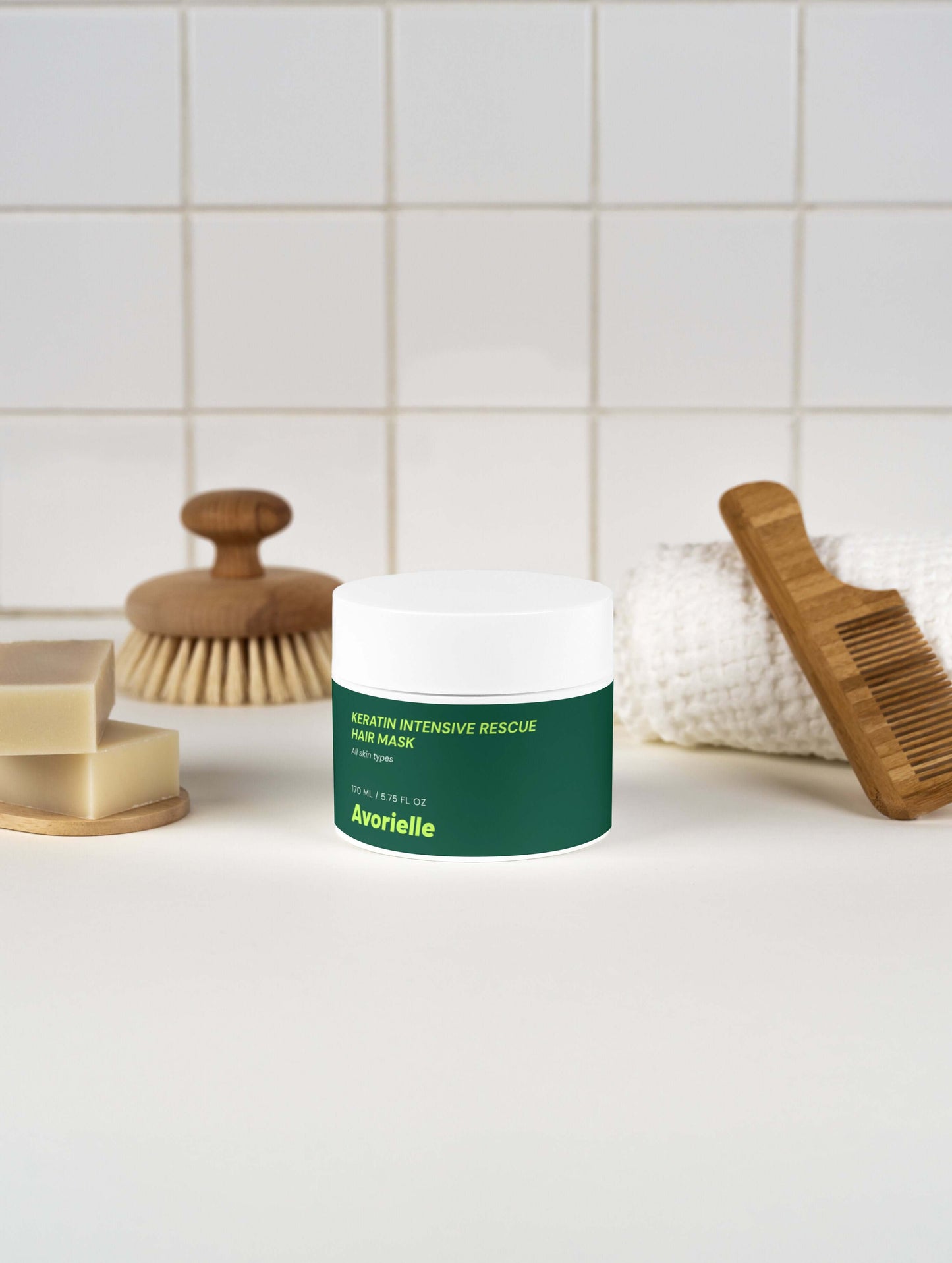 Keratin Intensive Rescue Hair Mask, a keratin hair mask for damaged hair, displayed on a countertop with comb and soap.